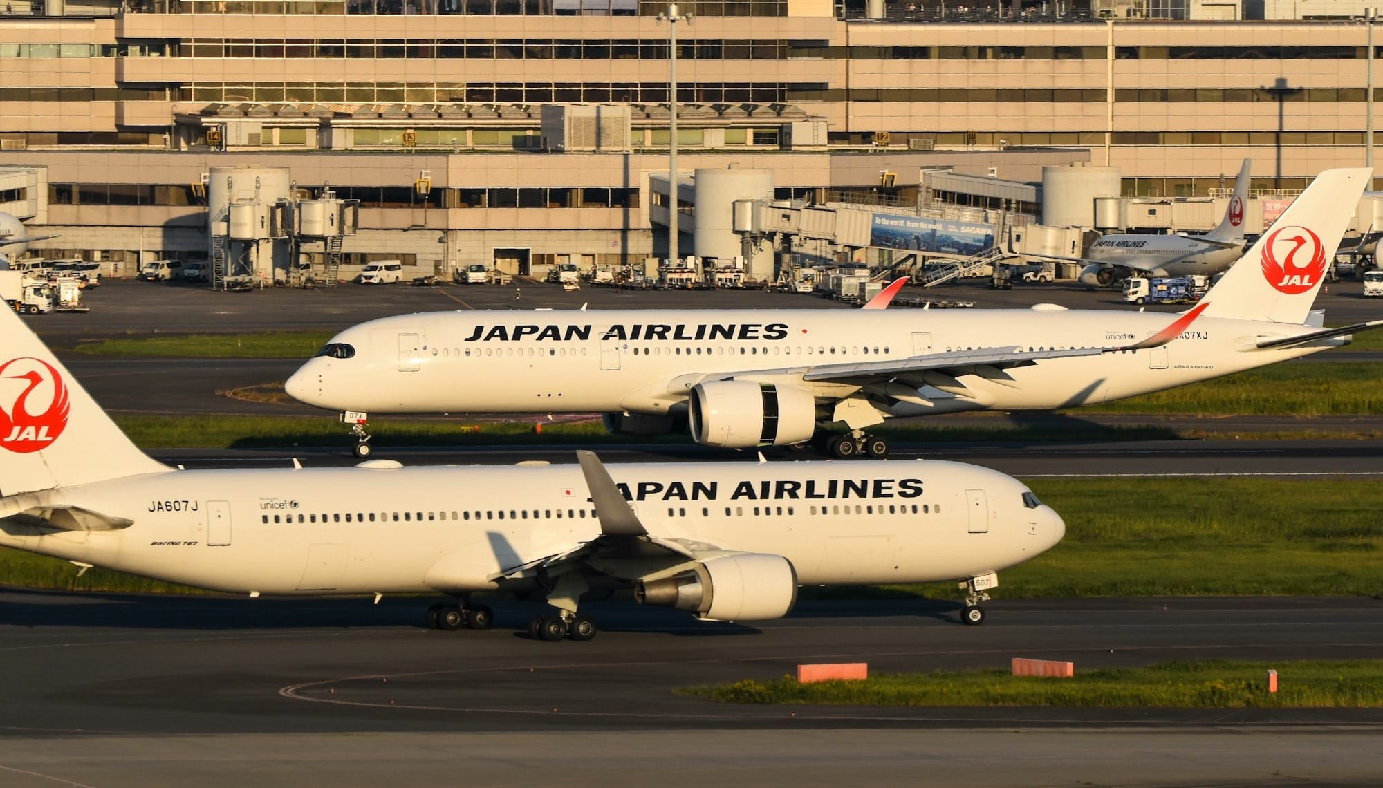 Two japan airlines airplanes on the tarmac