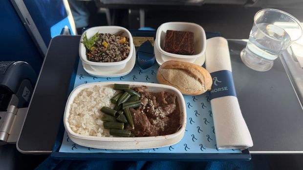 Norse Atlantic meal tray with beef, rice, green beans, a quinoa salad, a brownie and a bread roll