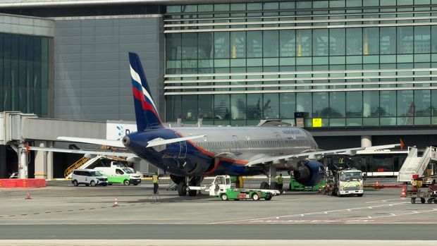 Aeroflot Airbus A321 parked at a terminal gate at Istanbul Airport, surrounded by ground crew and vehicles
