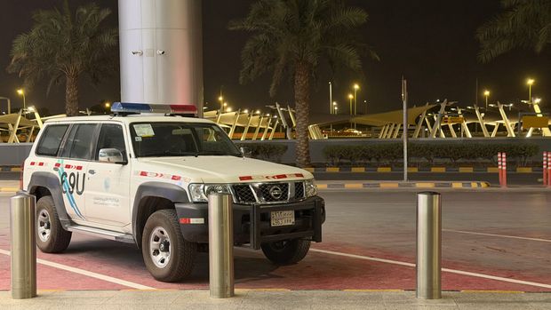 Saudi security SUV parked at the curb outside King Khalid International Airport in Riyadh at night
