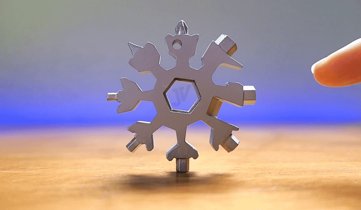 A snowflake multi-tool standing on one end on a countertop