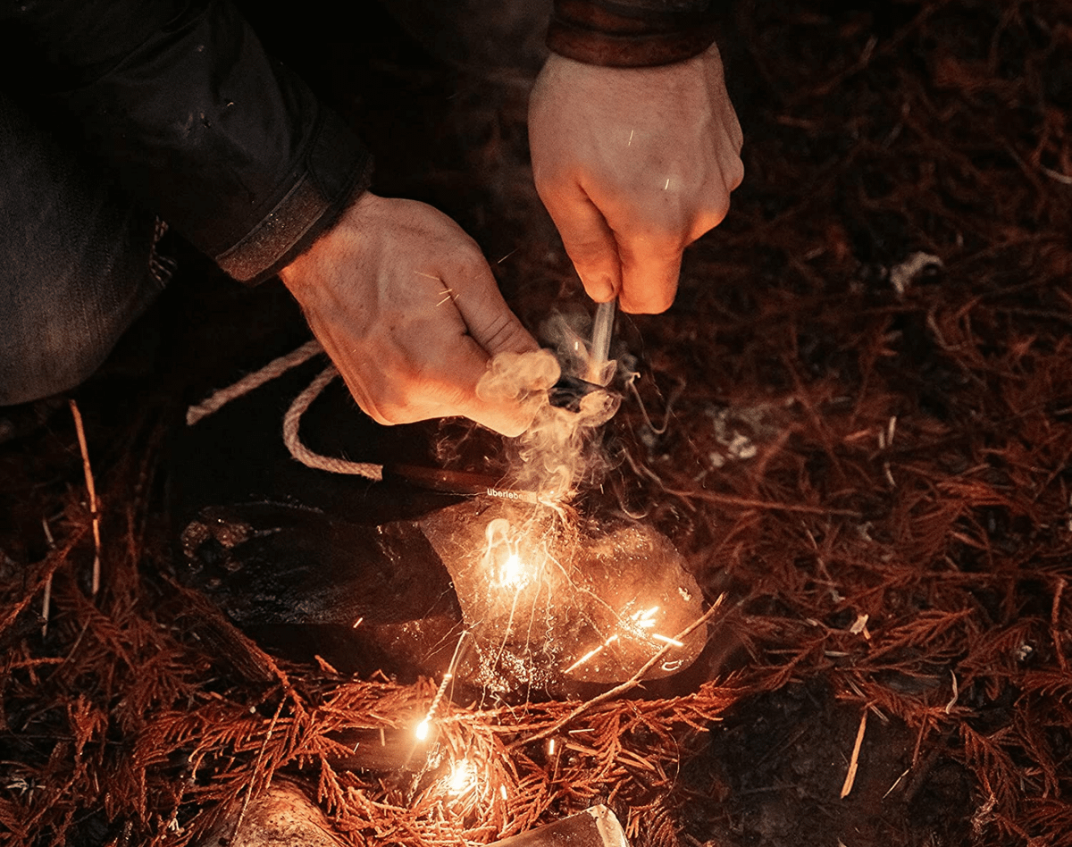 Starting a fire with a ferro rod, leaves and dry cedar twigs