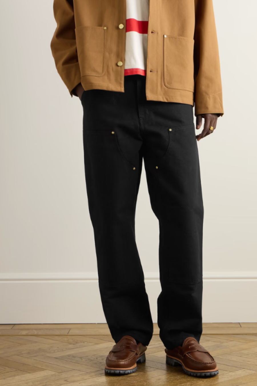 A man wearing black carpenter pants