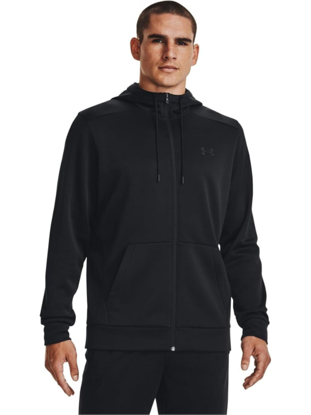 A man wearing a black Under Armour zip hoodie like a jacket