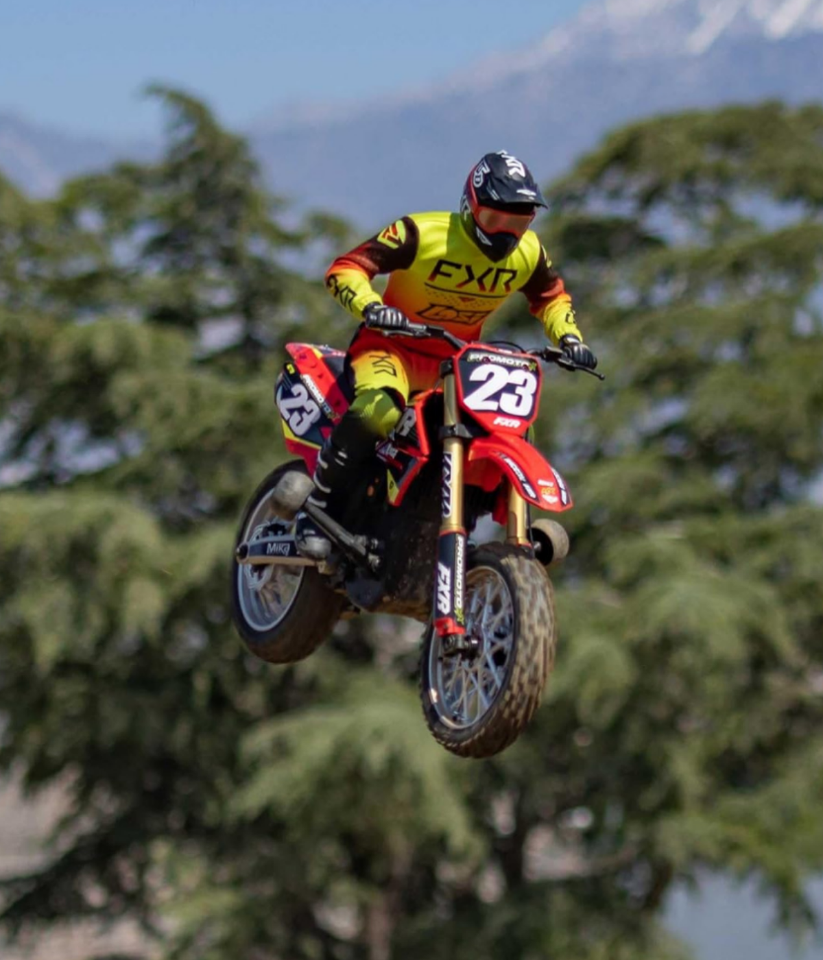 A red Promoto-MX drawing big air over a jump!