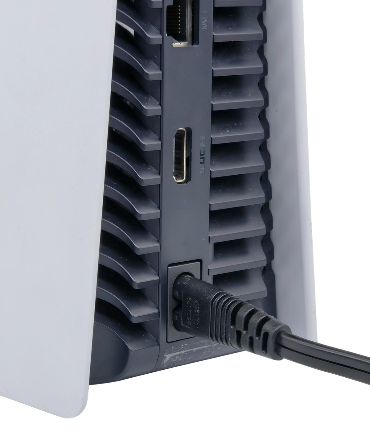 A closeup of the PS5 cord plugged into the PlayStation.