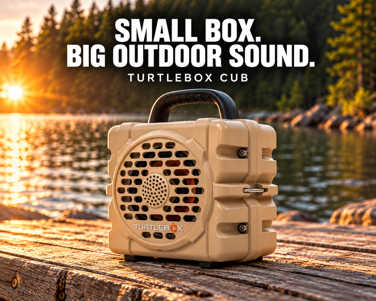 Tan Turtlebox Cub Bluetooth speaker on a wooden lakeside dock at sunset beneath the headline “Small Box. Big Outdoor Sound.”