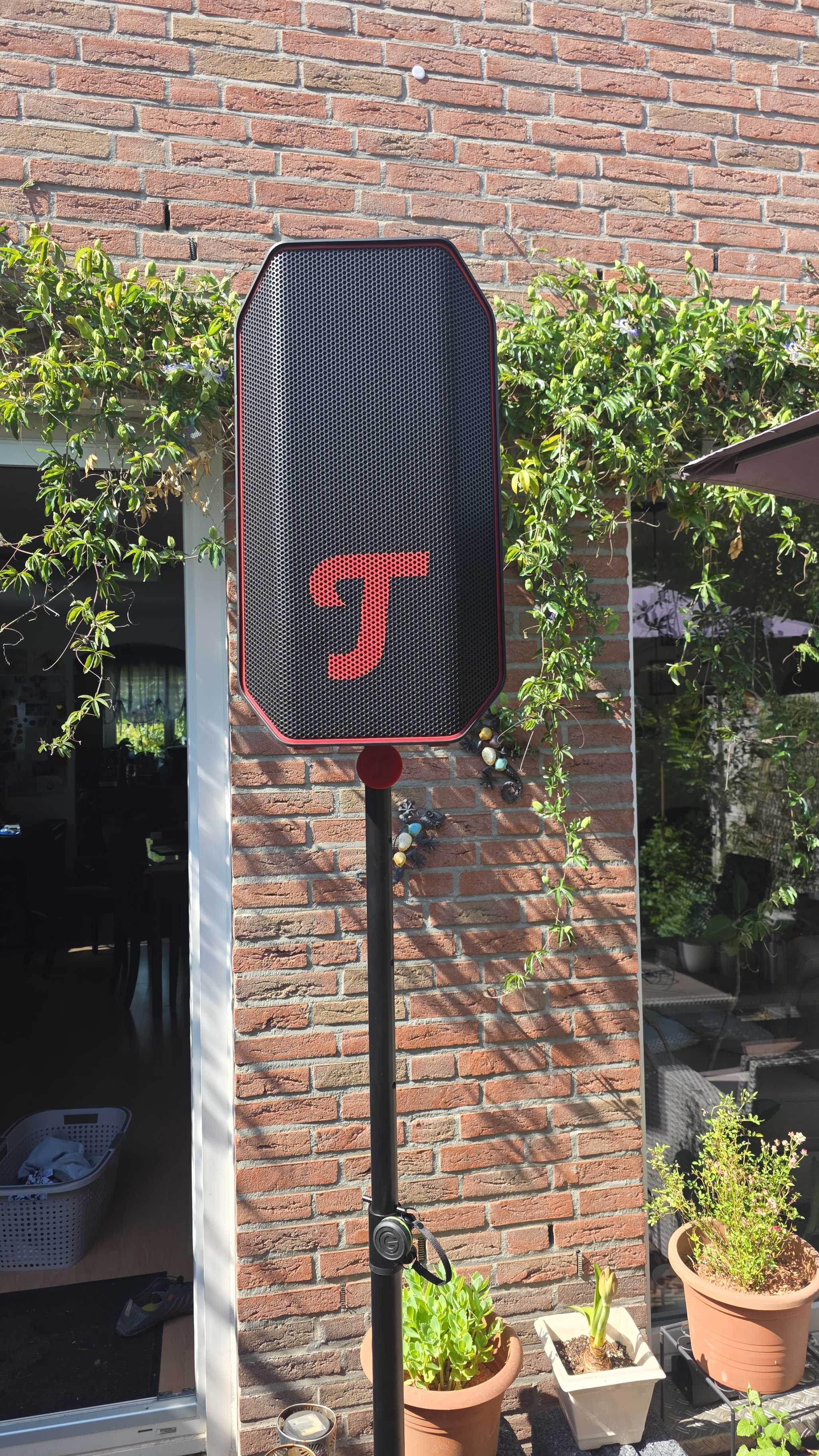 Teufel ROCKSTER AIR 2 set up on a stand in the garden