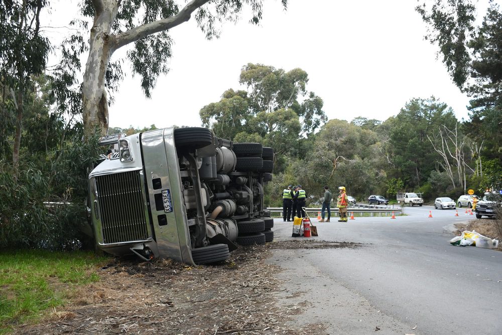 Driver escapes major injury when truck rolls post image