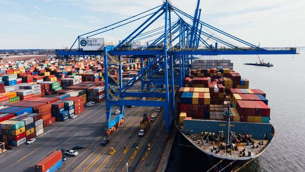 Container vessel and port cranes in the Zenith Eclipse ocean freight illustration.