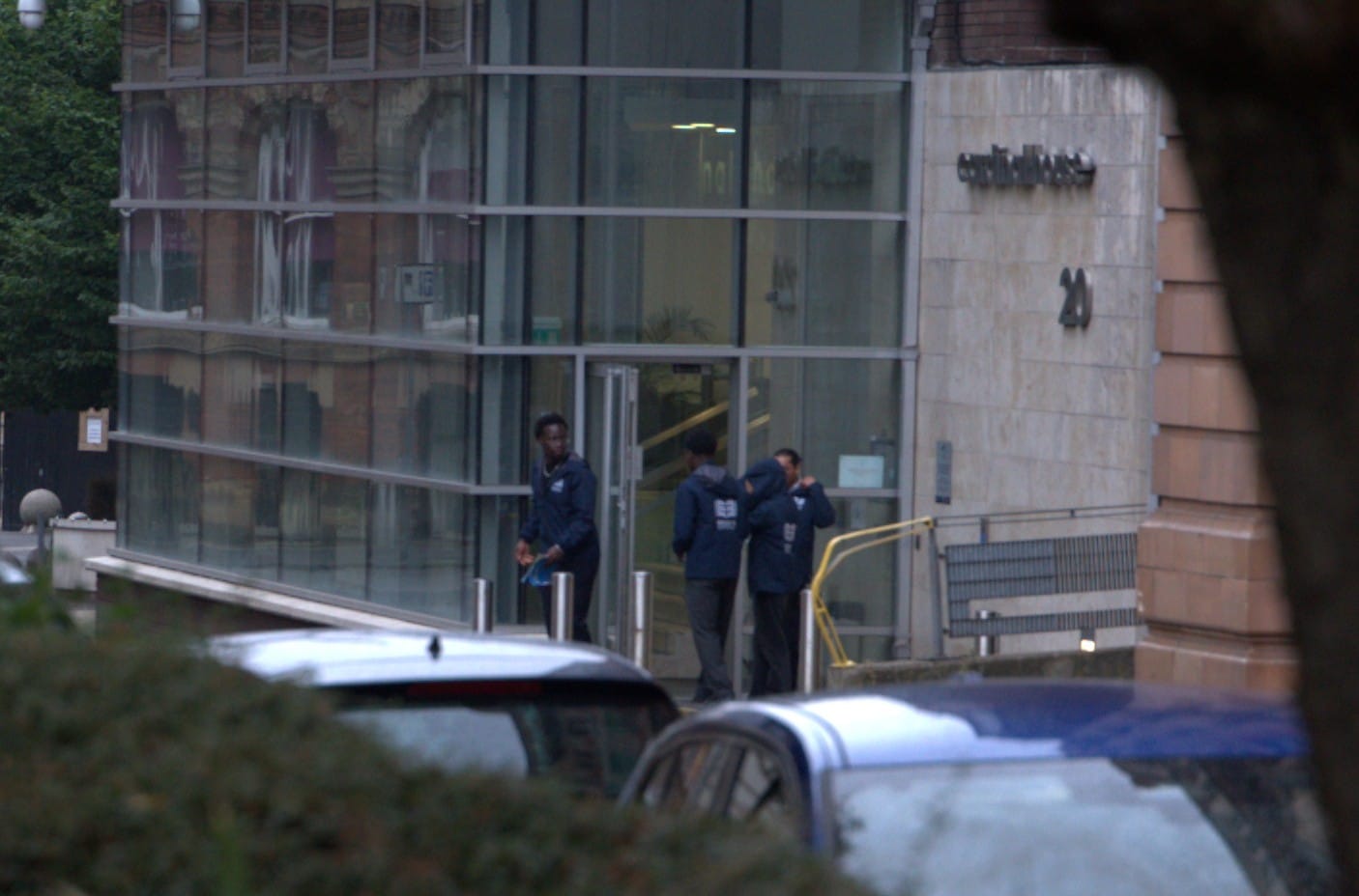Educate & Empower staff leaving the company's office, wearing blue jackets bearing the company logo