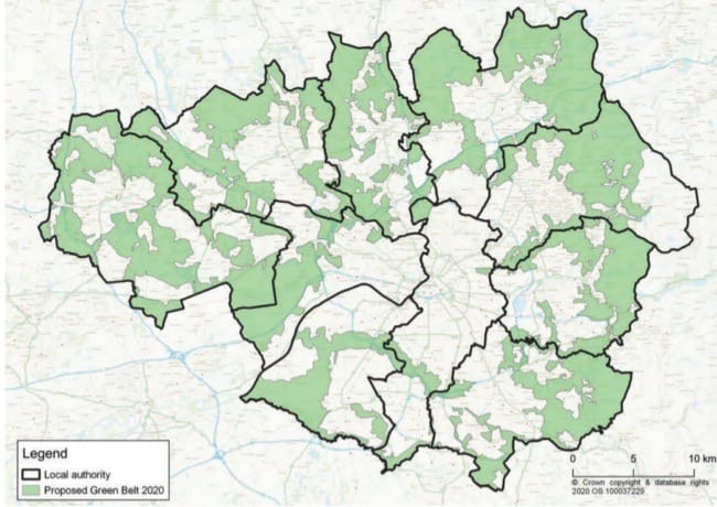 A map of Greater Manchester with the designated green belt in green,