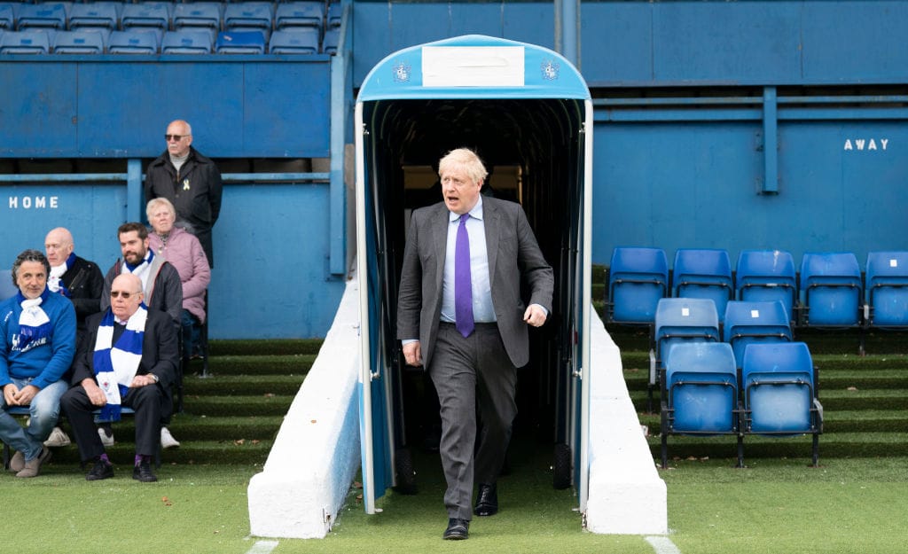 Boris Johnson visiting Gigg Lane in 2022, a few months after fans bought the stadium with money from the Department of Levelling Up. Photo: WPA Pool via Getty.