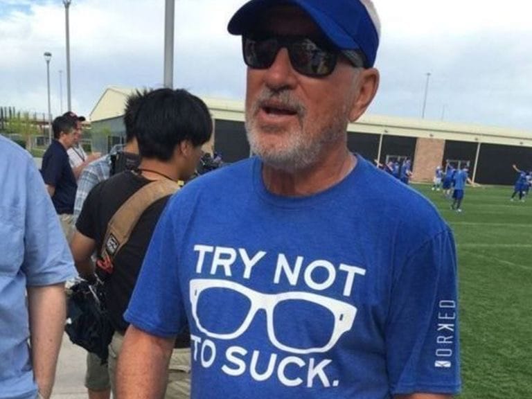 Joe Maddon wears a blue shirt with the text "Try Not To Suck."