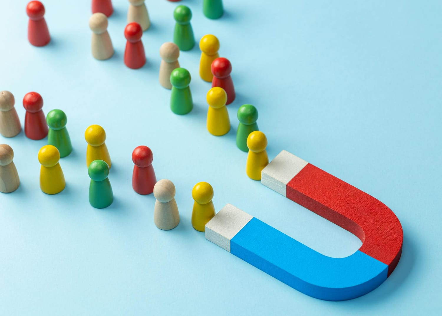 Portrayal of customer attraction via magnet and chess pieces.