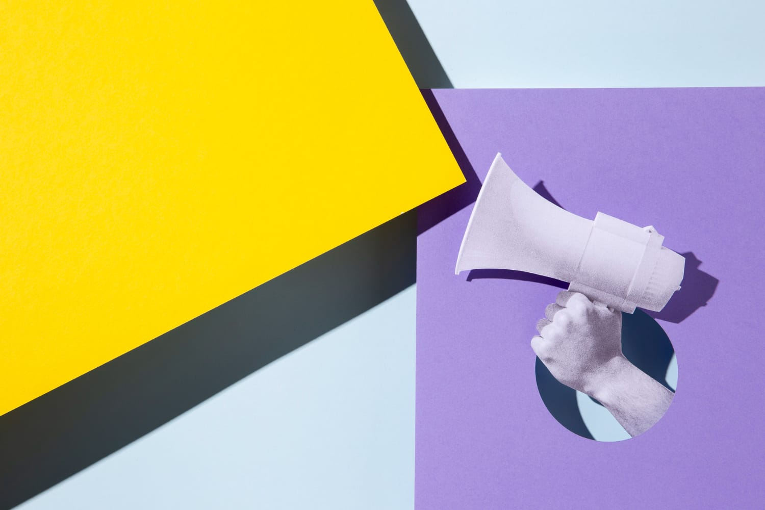 A hand holding a speaker.