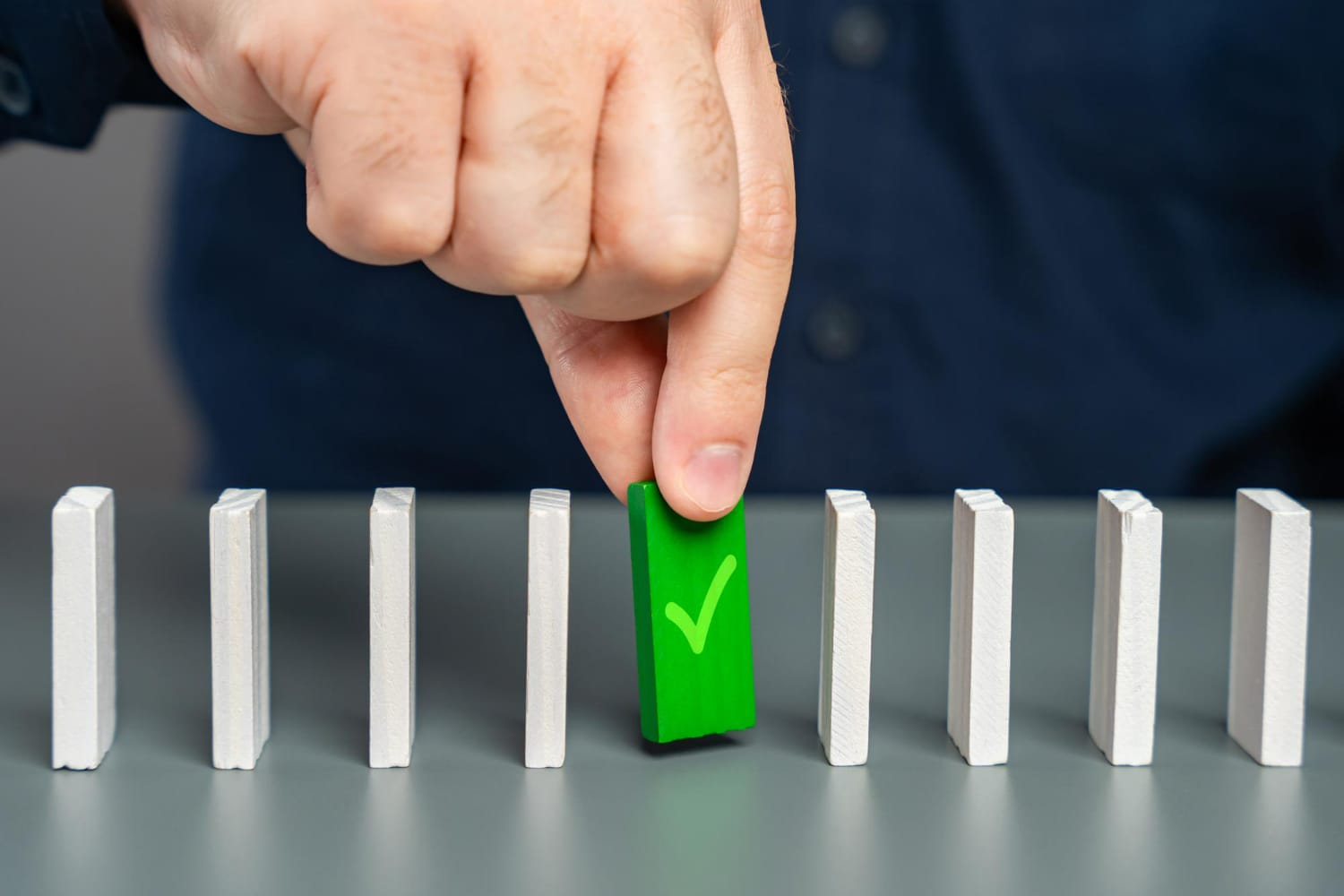 A man playing with domino pieces.