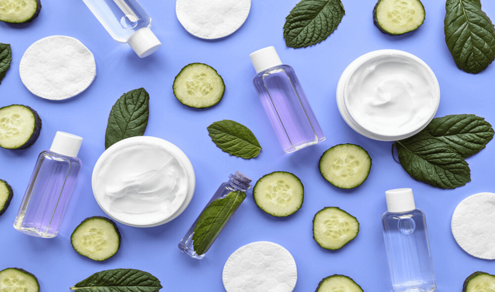 An image showing skincare & beauty products in purple, white, and green.
