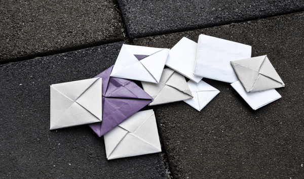 Undelivered mails are scattered on the grey road. 