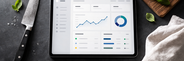 Calculator and receipt next to fresh ingredients representing personal chef pricing