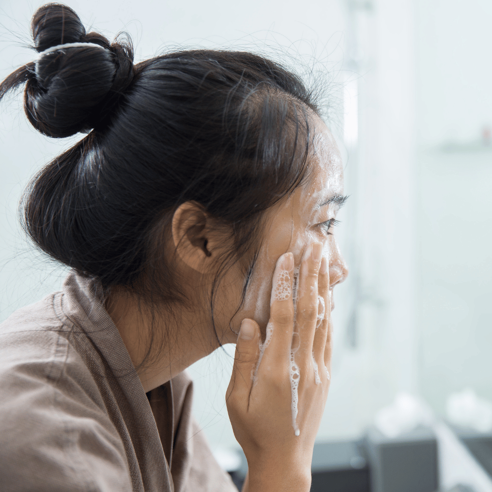 woman washing her face