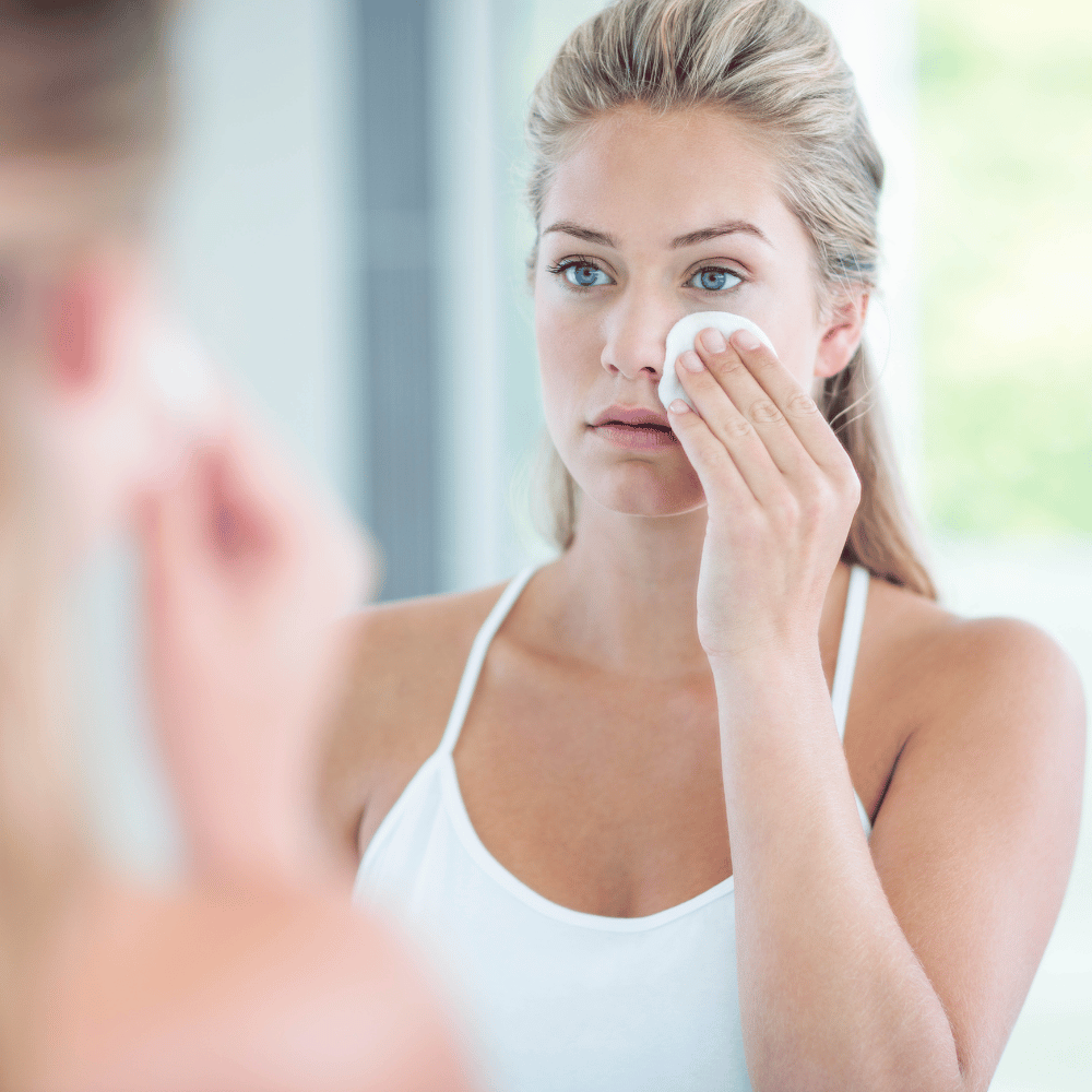 girl applying toner to her face