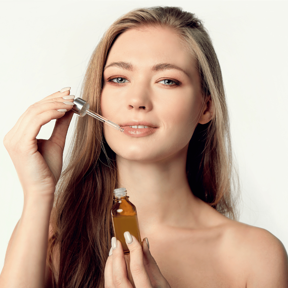woman holding a serum bottle and dropper