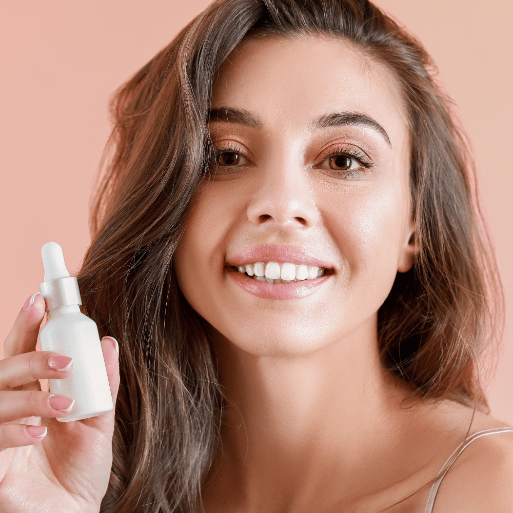 woman holding holding a bottle of serum