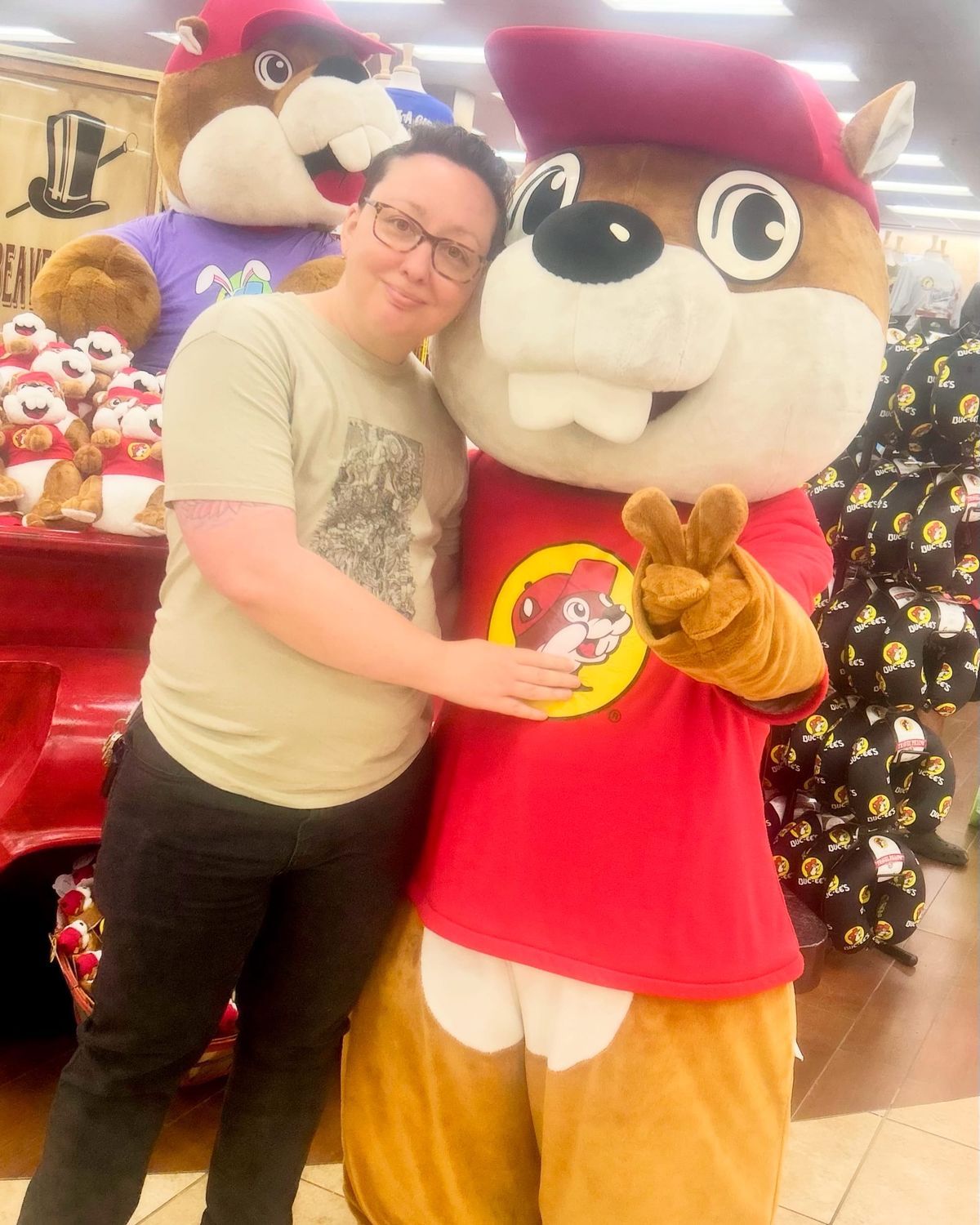 A photo of me posing with someone in a Buc-ee’s beaver mascot outfit in a Buc-ee’s store