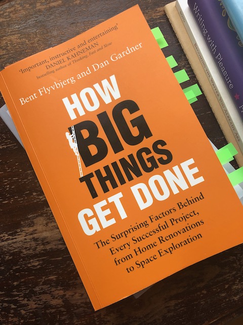 Cover of the book How Big Things Get Done, black and white text on orange background