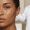 Close-up of medium-deep brown skin showing two pigment marks with different tonal qualities