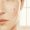 Close view of two post-breakout marks on light-medium skin, one brown and one pinkish-red.