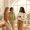 Three women with different skin tones standing together near a window in natural light