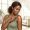 Woman adjusting a clothing strap on her shoulder