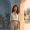 Woman at the boundary between indoor shade and warm outdoor light