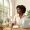 Woman between screen light and window light, looking outward.