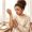 Woman examining inner elbow showing skin irritation alongside darker patches