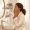 Woman gently touching her cheek to assess her skin