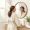 Woman looking at her clear skin in a bathroom mirror with calm satisfaction