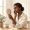 Woman looking at her face in a handheld mirror