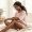 Woman looking at the skin on her knee with a calm expression