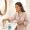 Woman organising her morning skincare and supplement routine on the bathroom counter