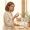 Woman reconsidering a skincare product at her bathroom vanity