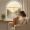 Woman sitting by a window in the morning holding a mug