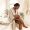 Woman sitting on a bathtub edge looking at her leg with a razor nearby