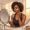 Woman with deep brown skin carefully applying a small amount of retinoid to her cheek in evening light