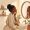 Woman with deep brown skin examining her jawline in a bathroom mirror
