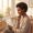 Woman with deep brown skin reviewing treatment pathway options on a tablet in a calm consultation setting