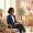 Woman with deep brown skin sitting calmly in a dermatologist's waiting area in natural light