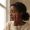 Woman with melanin-rich skin in natural light